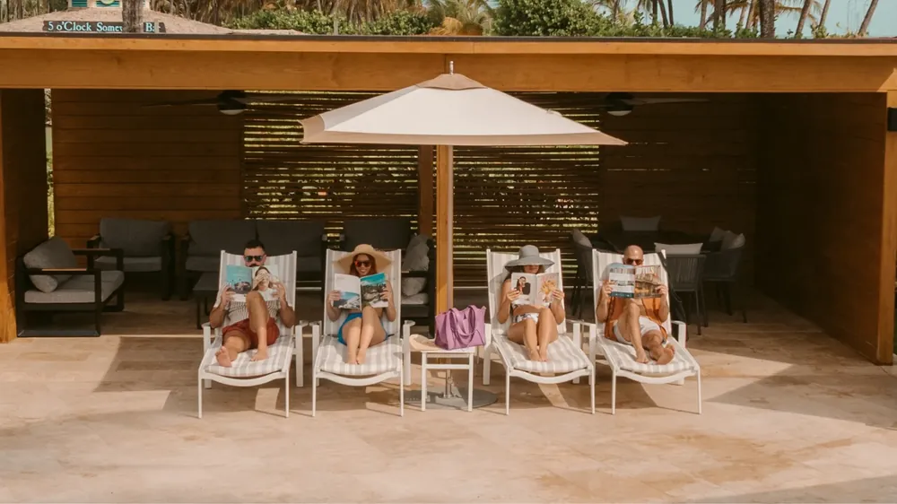Guests lounging at a beach cabana